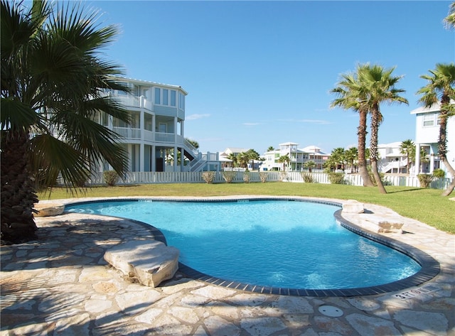 view of swimming pool featuring a patio and a lawn