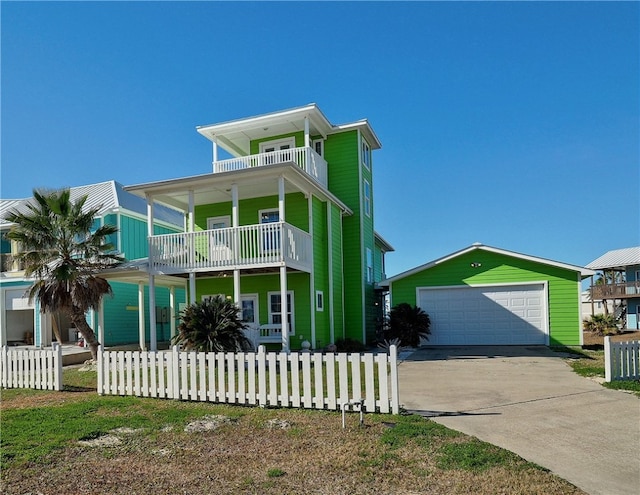 coastal home with an outbuilding, a balcony, and a garage