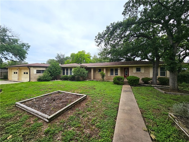 single story home featuring a garage and a front yard