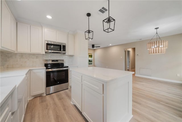 kitchen featuring a kitchen island, white cabinets, backsplash, hanging light fixtures, and stainless steel appliances