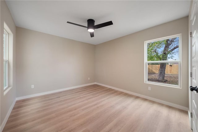 empty room with light hardwood / wood-style flooring and ceiling fan