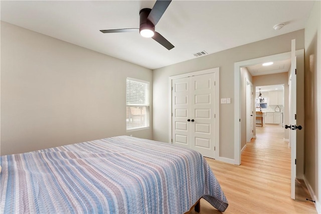 1233 Brentwood Dr, Corpus Christi, TX 78404 - bedroom with light wood-type flooring, a ceiling fan, a closet, and baseboards