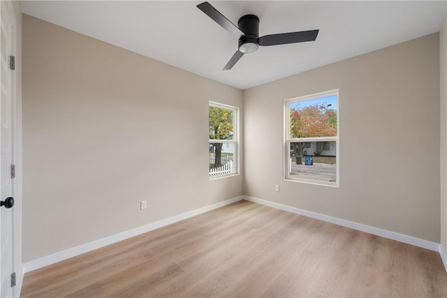 empty room with ceiling fan and light wood-type flooring