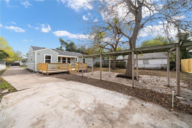 rear view of property featuring a wooden deck