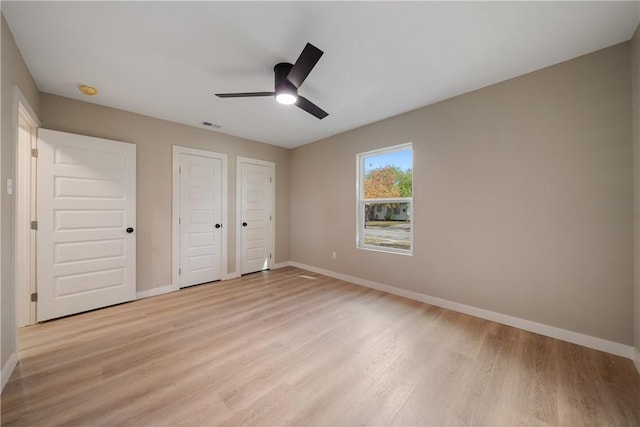 unfurnished bedroom with ceiling fan and light hardwood / wood-style floors