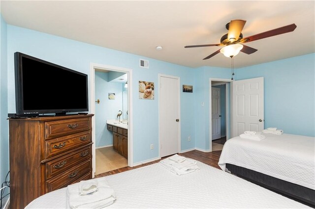 bedroom with light hardwood / wood-style floors, ceiling fan, and ensuite bathroom