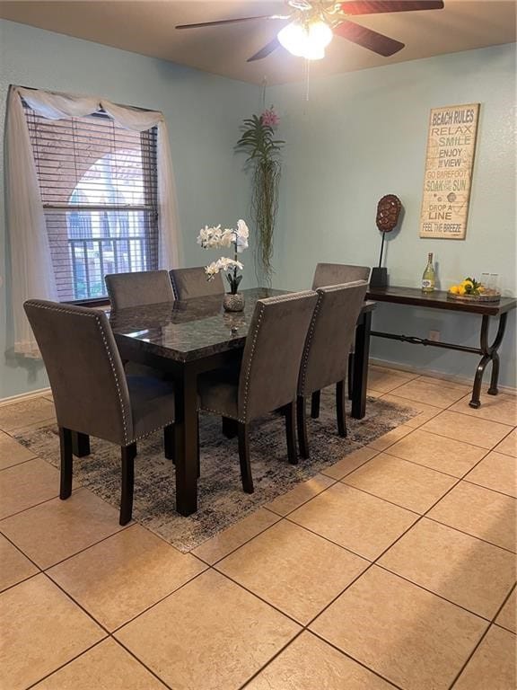 dining space featuring light tile patterned floors and ceiling fan