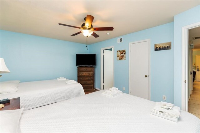 bedroom with wood-type flooring and ceiling fan