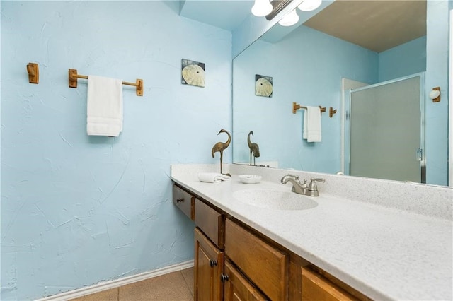 bathroom featuring vanity, an enclosed shower, and tile patterned floors