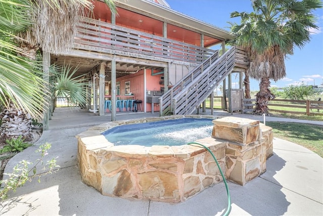 view of swimming pool featuring an outdoor bar and a wooden deck