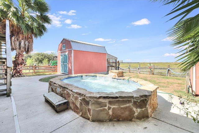 view of swimming pool with a storage unit and a rural view