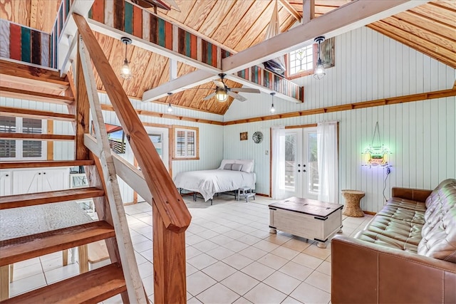 tiled bedroom featuring french doors, wood ceiling, wooden walls, and high vaulted ceiling