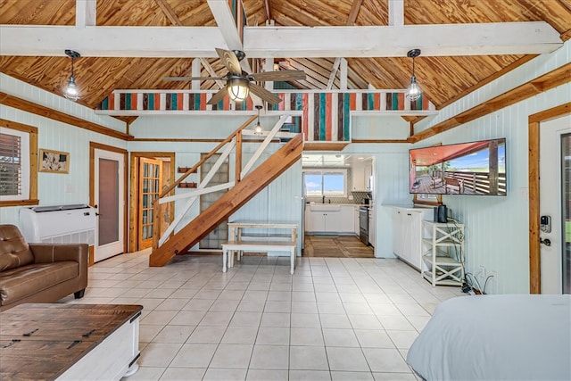 living room featuring light tile patterned flooring, ceiling fan, and vaulted ceiling with beams