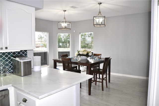 dining room featuring plenty of natural light and light wood-type flooring