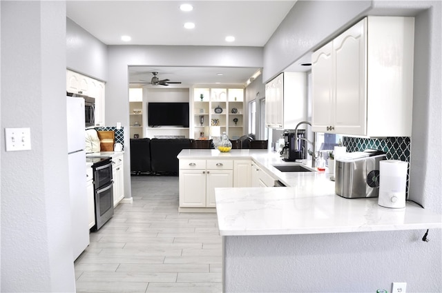 kitchen with white cabinets, sink, ceiling fan, kitchen peninsula, and stainless steel appliances