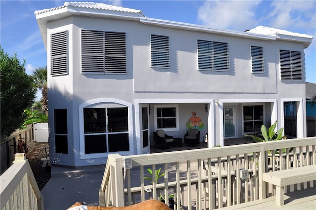 back of house with an outdoor living space