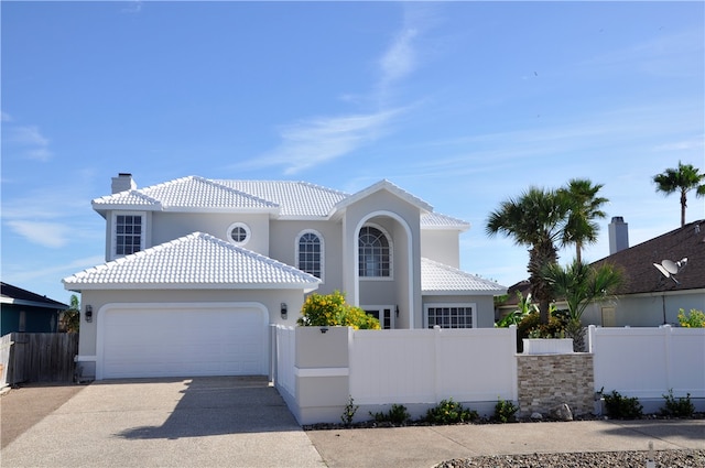 mediterranean / spanish home featuring a garage