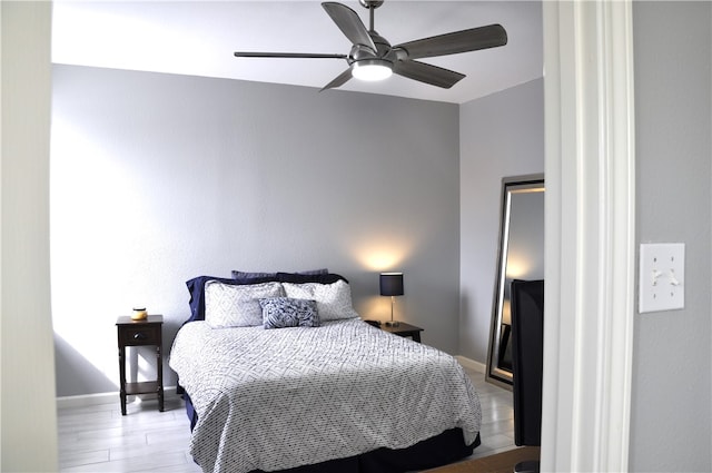 bedroom with ceiling fan and light hardwood / wood-style floors