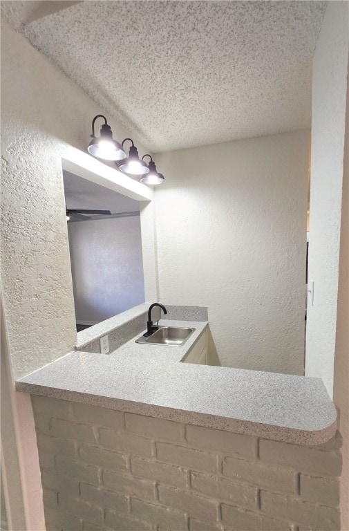 bathroom featuring a textured ceiling and sink