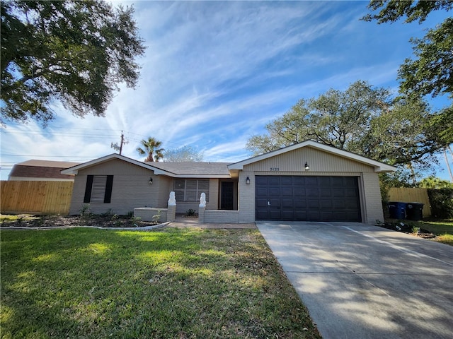 ranch-style house featuring a front lawn and a garage