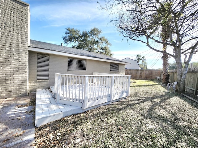 exterior space with a deck and a lawn