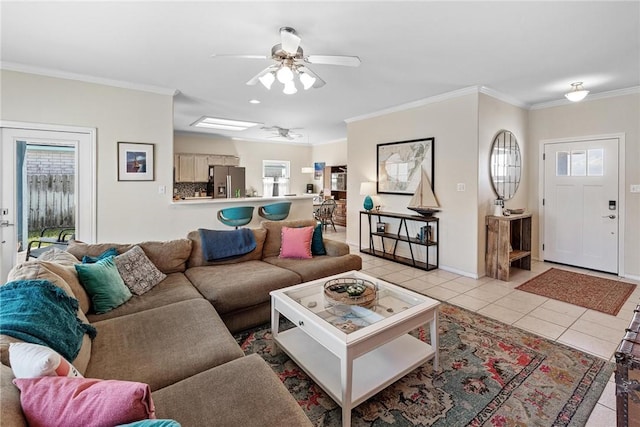 living area featuring light tile patterned floors, a wealth of natural light, and crown molding