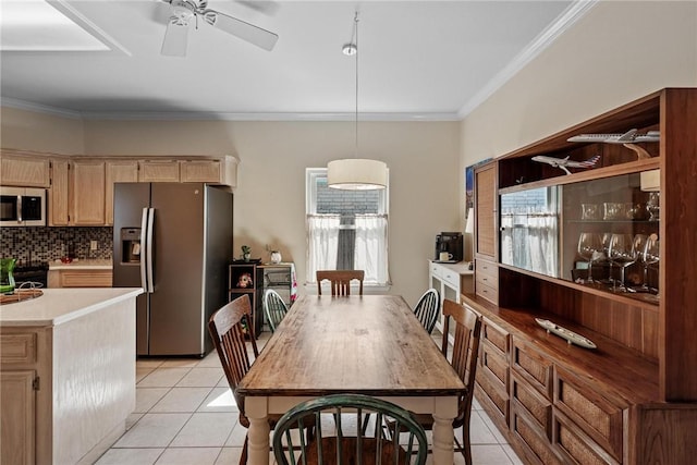 dining space featuring ornamental molding, a ceiling fan, and light tile patterned flooring