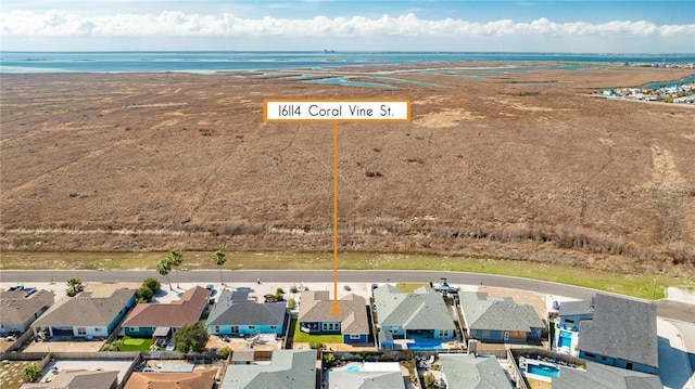 drone / aerial view featuring a water view and a residential view