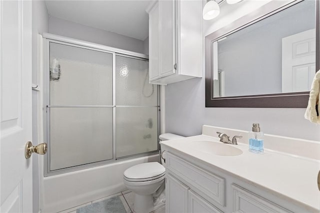 full bath featuring toilet, tile patterned flooring, bath / shower combo with glass door, and vanity