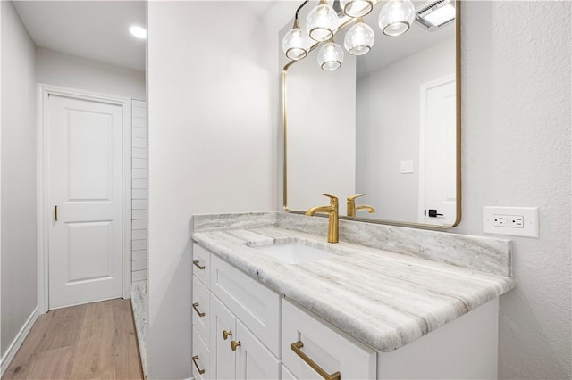 1109 Adeline St, Sinton, TX 78387 - bathroom with wood finished floors, vanity, and a chandelier