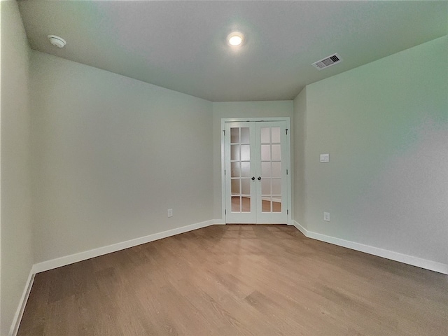 3002 Stone Creek Dr, Corpus Christi, TX 78410 - empty room with french doors, wood finished floors, and baseboards