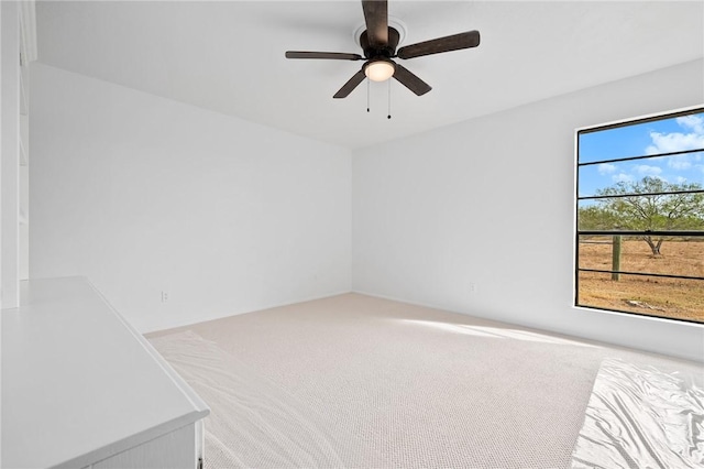 empty room featuring carpet and ceiling fan