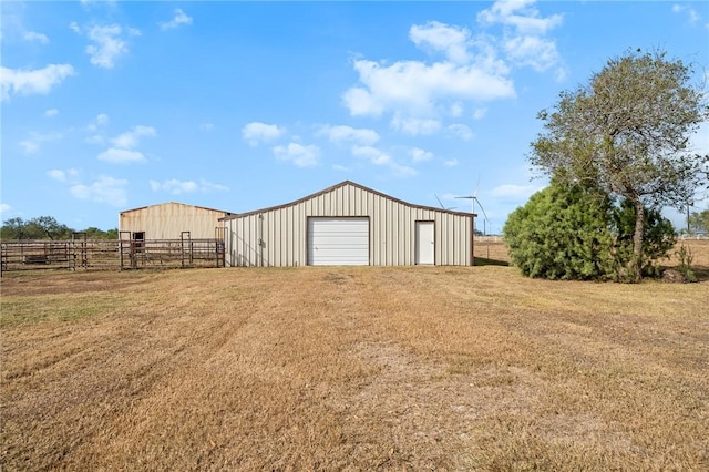 view of yard with an outbuilding, a rural view, and a garage