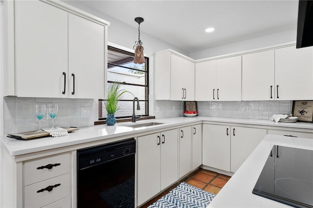 kitchen featuring white cabinetry, sink, backsplash, pendant lighting, and black appliances