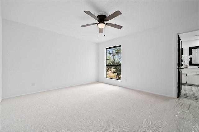 carpeted spare room with ceiling fan