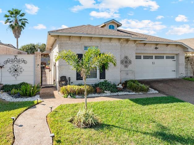 view of front of property with a front yard and a garage