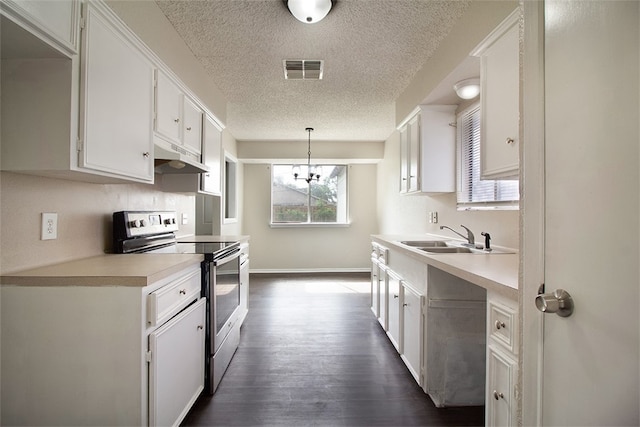 kitchen with a sink, a textured ceiling, stainless steel range with electric stovetop, and under cabinet range hood
