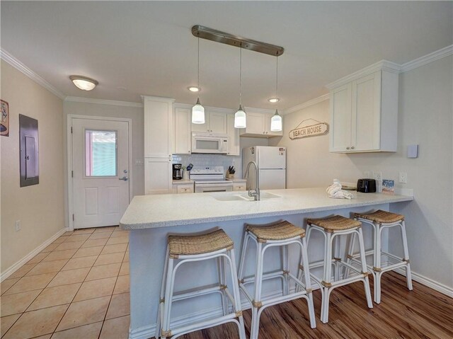 800 Beach Access Road 1a 509, Port Aransas, TX 78373 - kitchen with white appliances, a sink, baseboards, electric panel, and a peninsula