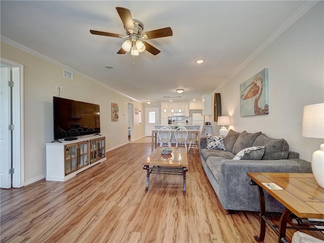 800 Beach Access Road 1a 509, Port Aransas, TX 78373 - living area with crown molding, light wood-style flooring, ceiling fan, and baseboards