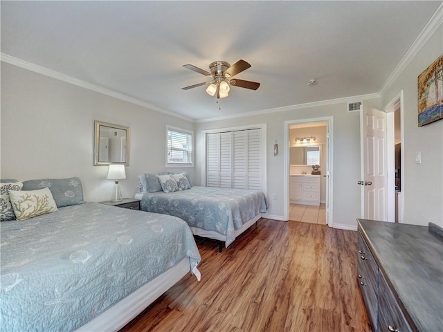 800 Beach Access Road 1a 509, Port Aransas, TX 78373 - bedroom featuring wood finished floors, crown molding, ceiling fan, baseboards, and ensuite bath