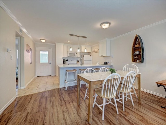 800 Beach Access Road 1a 509, Port Aransas, TX 78373 - dining area with ornamental molding, baseboards, and light wood-style floors