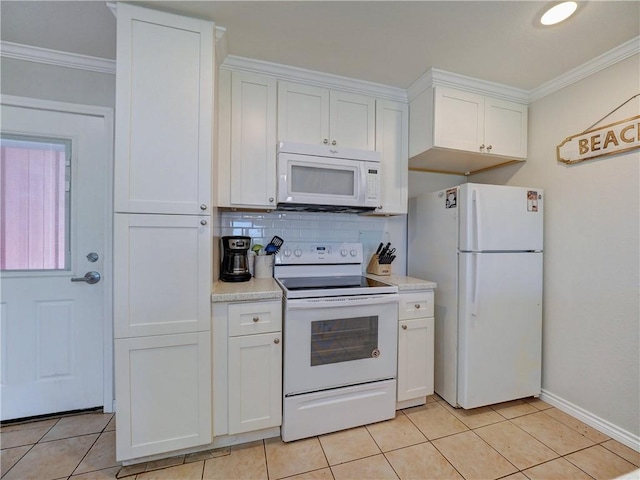 800 Beach Access Road 1a 509, Port Aransas, TX 78373 - kitchen featuring white appliances, ornamental molding, light countertops, white cabinets, and light tile patterned floors