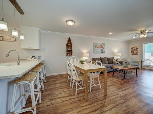 800 Beach Access Road 1a 509, Port Aransas, TX 78373 - dining room with light wood-type flooring, crown molding, baseboards, ceiling fan, and recessed lighting