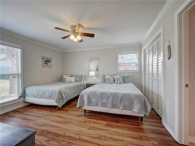 800 Beach Access Road 1a 509, Port Aransas, TX 78373 - bedroom featuring crown molding, wood finished floors, baseboards, ceiling fan, and a closet