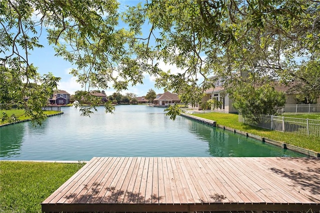 dock area with a yard and a water view