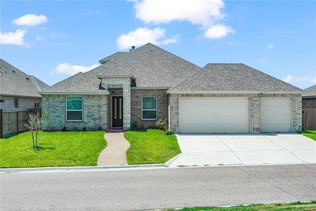 view of front facade featuring a garage and a front lawn