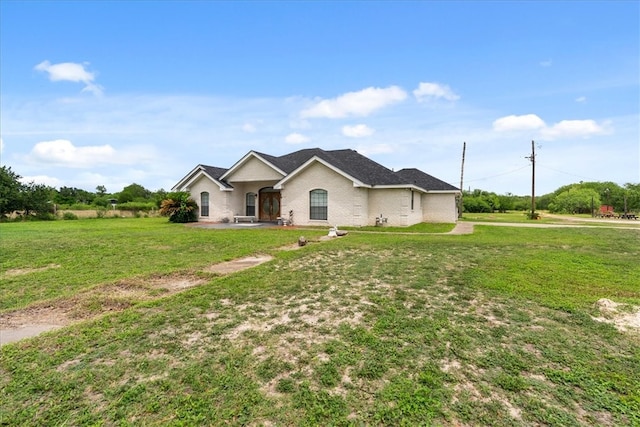 ranch-style home featuring a front yard and a patio