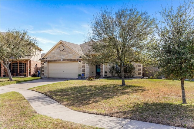 view of front of house featuring stone siding, driveway, an attached garage, and a front yard