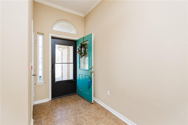 entryway with a wealth of natural light, light tile patterned floors, baseboards, and ornamental molding