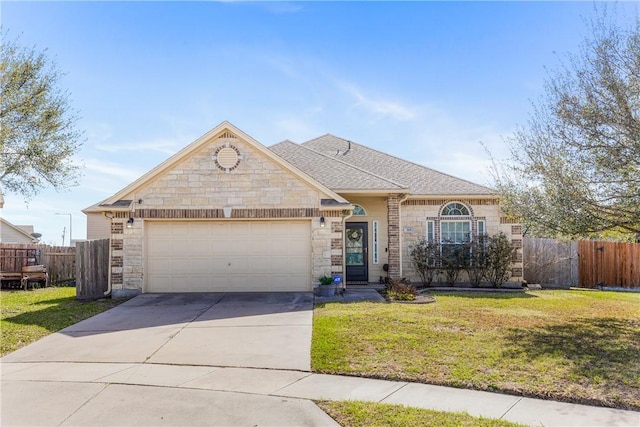 view of front of home featuring fence, concrete driveway, roof with shingles, a front yard, and a garage